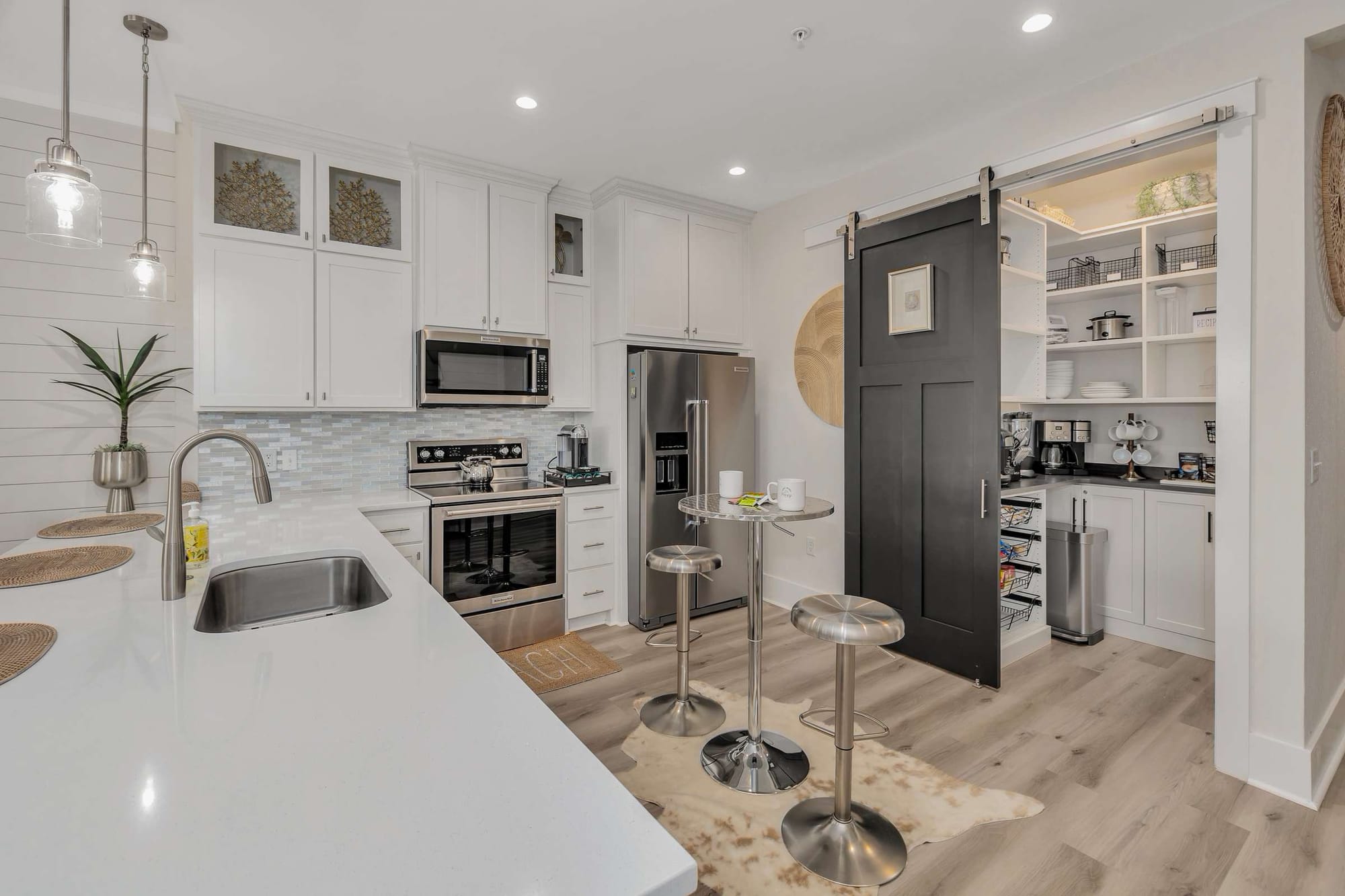 Modern kitchen with sliding pantry door.