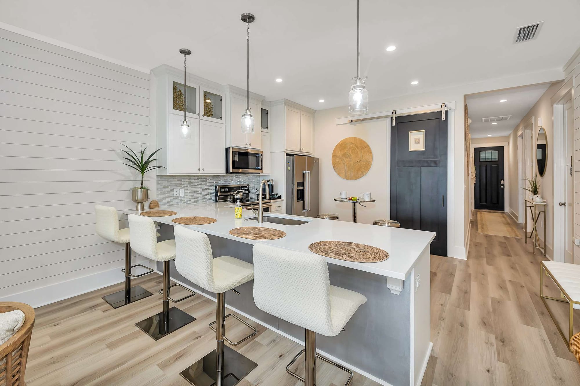 Modern kitchen with island and stools.