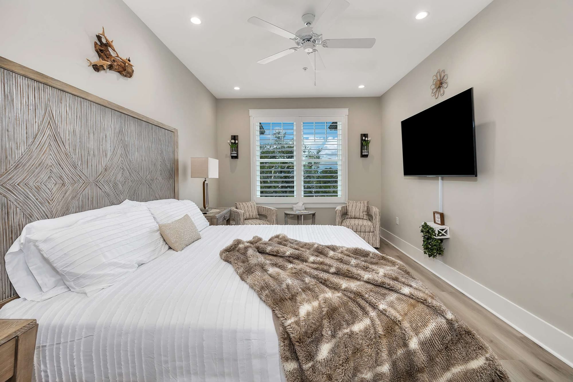 Modern bedroom with TV and window.