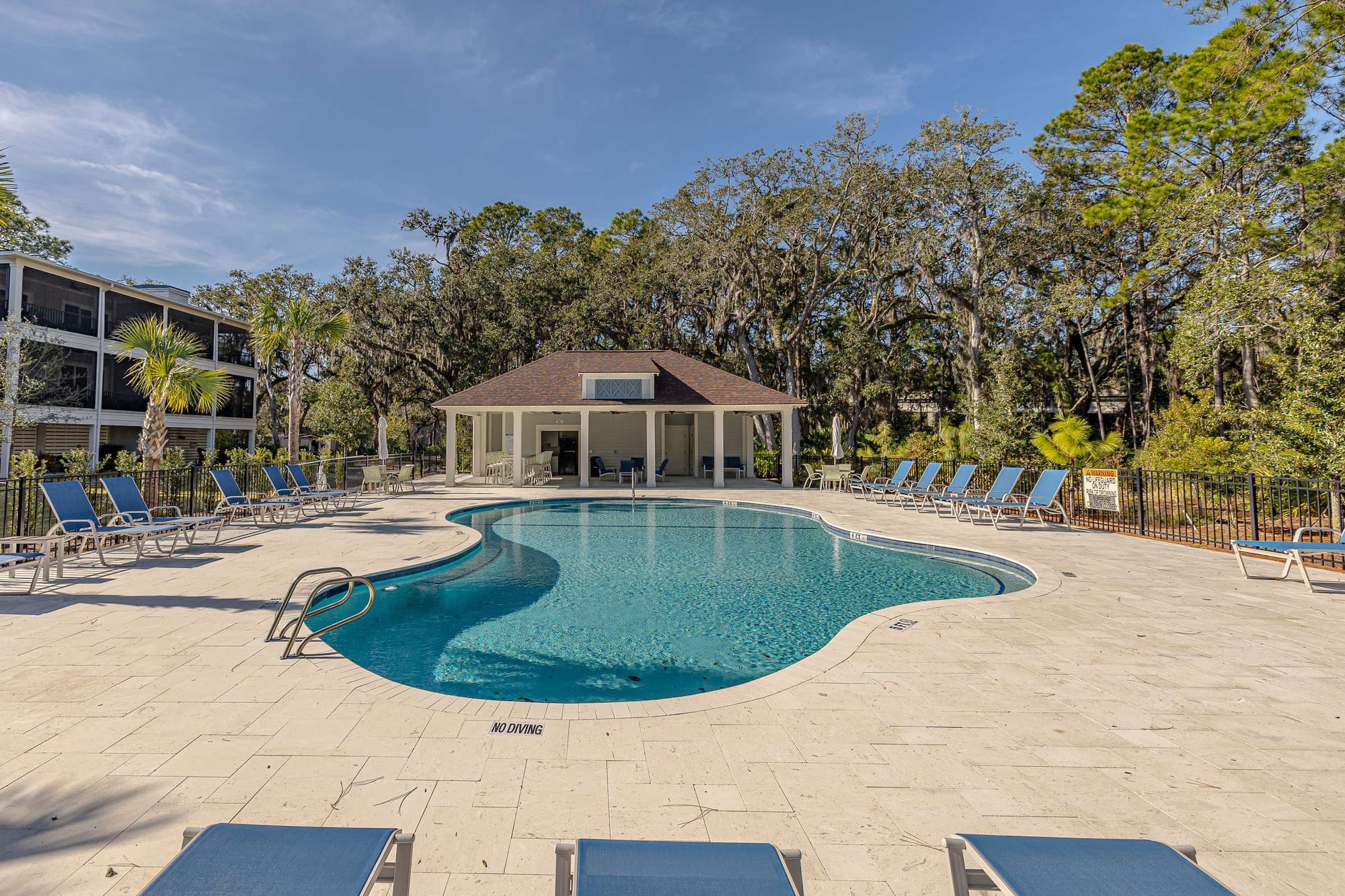 Outdoor pool with lounge chairs.