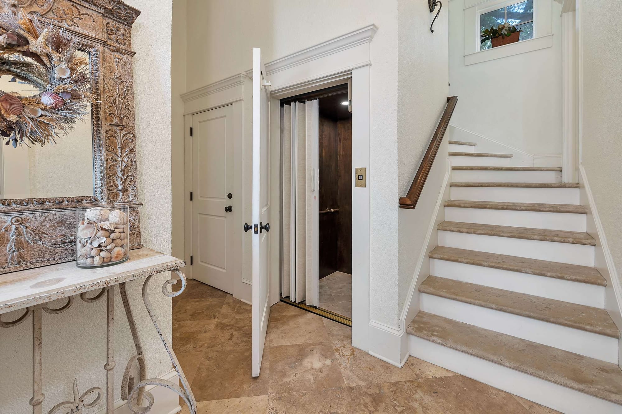 Home interior with elevator and stairs.