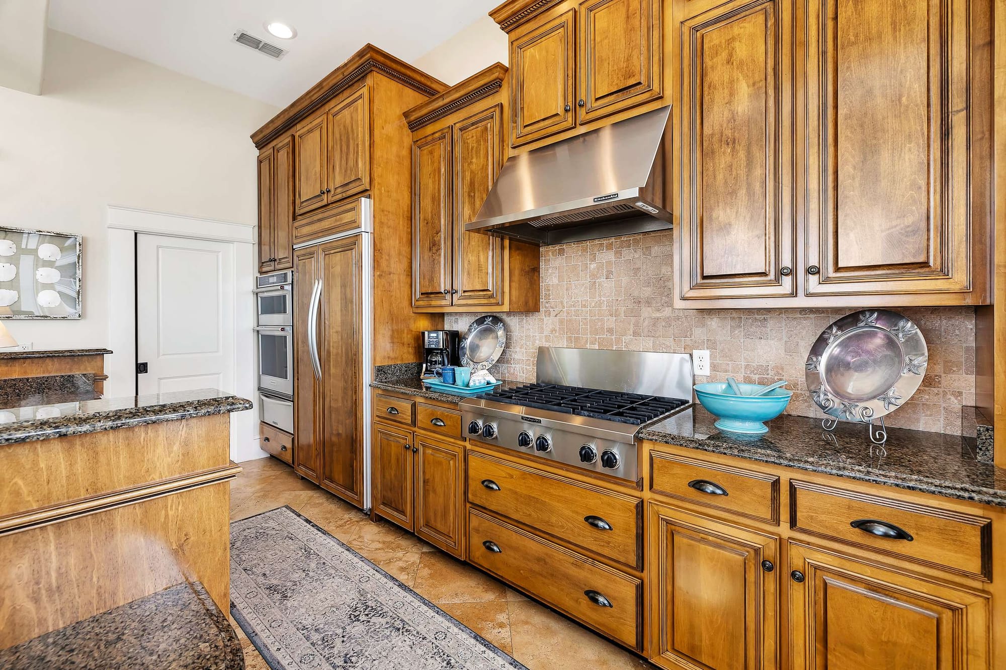 Wooden kitchen cabinets with granite countertops.