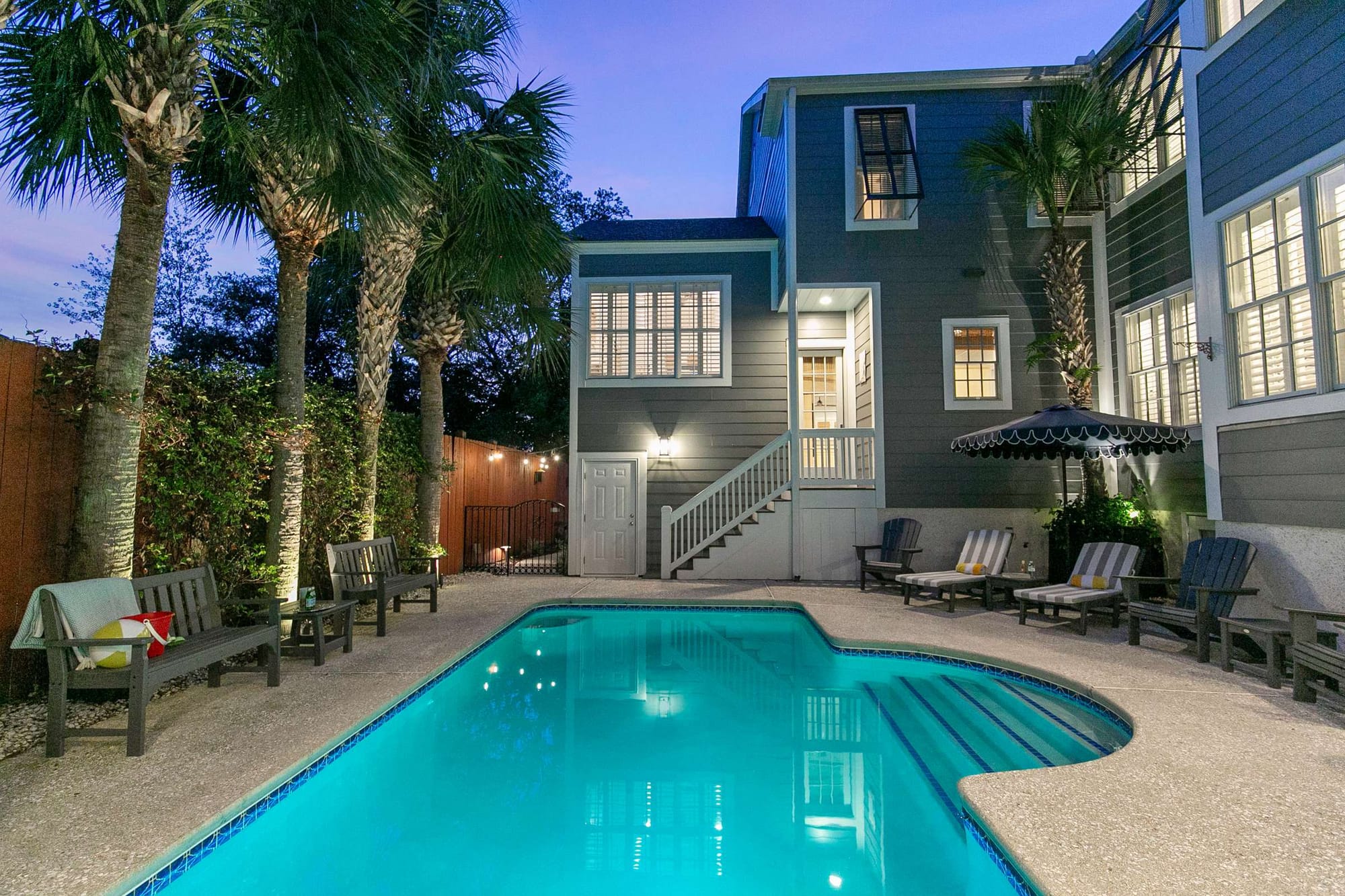 House with pool and palm trees.