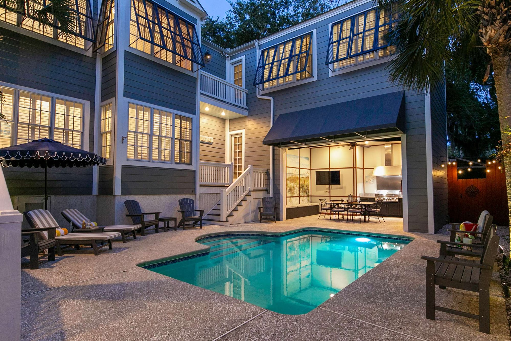 Backyard pool with patio seating.