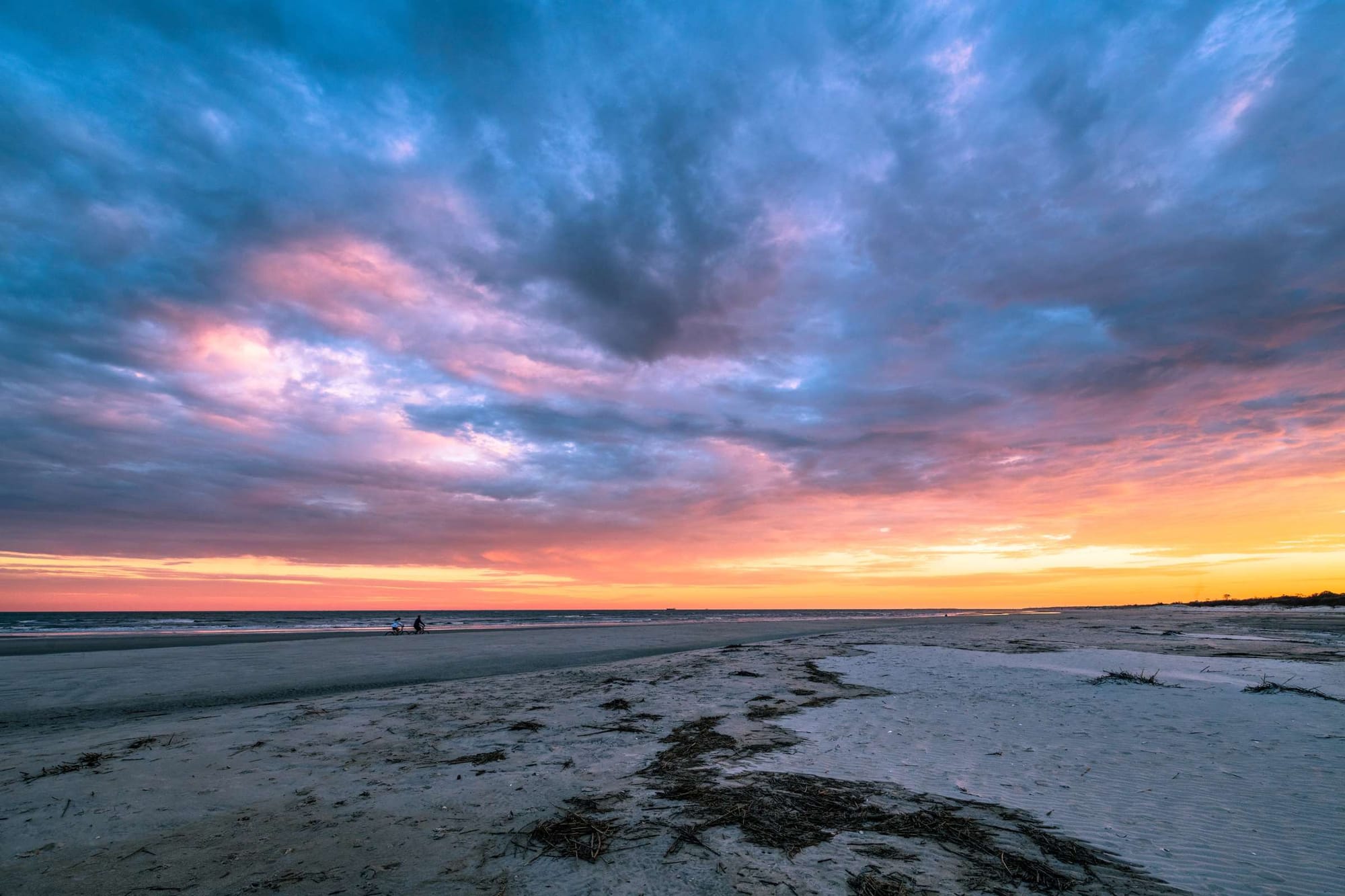 Colorful sunset over beach horizon.