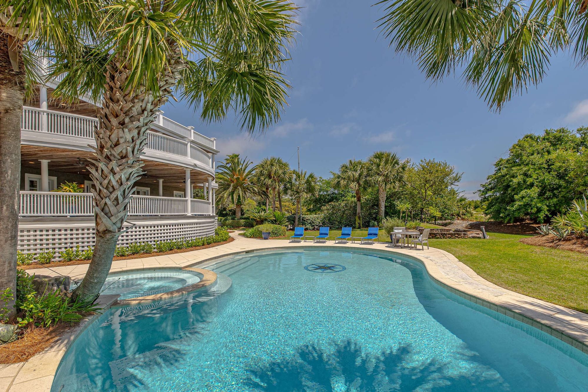 House with pool and palm trees.