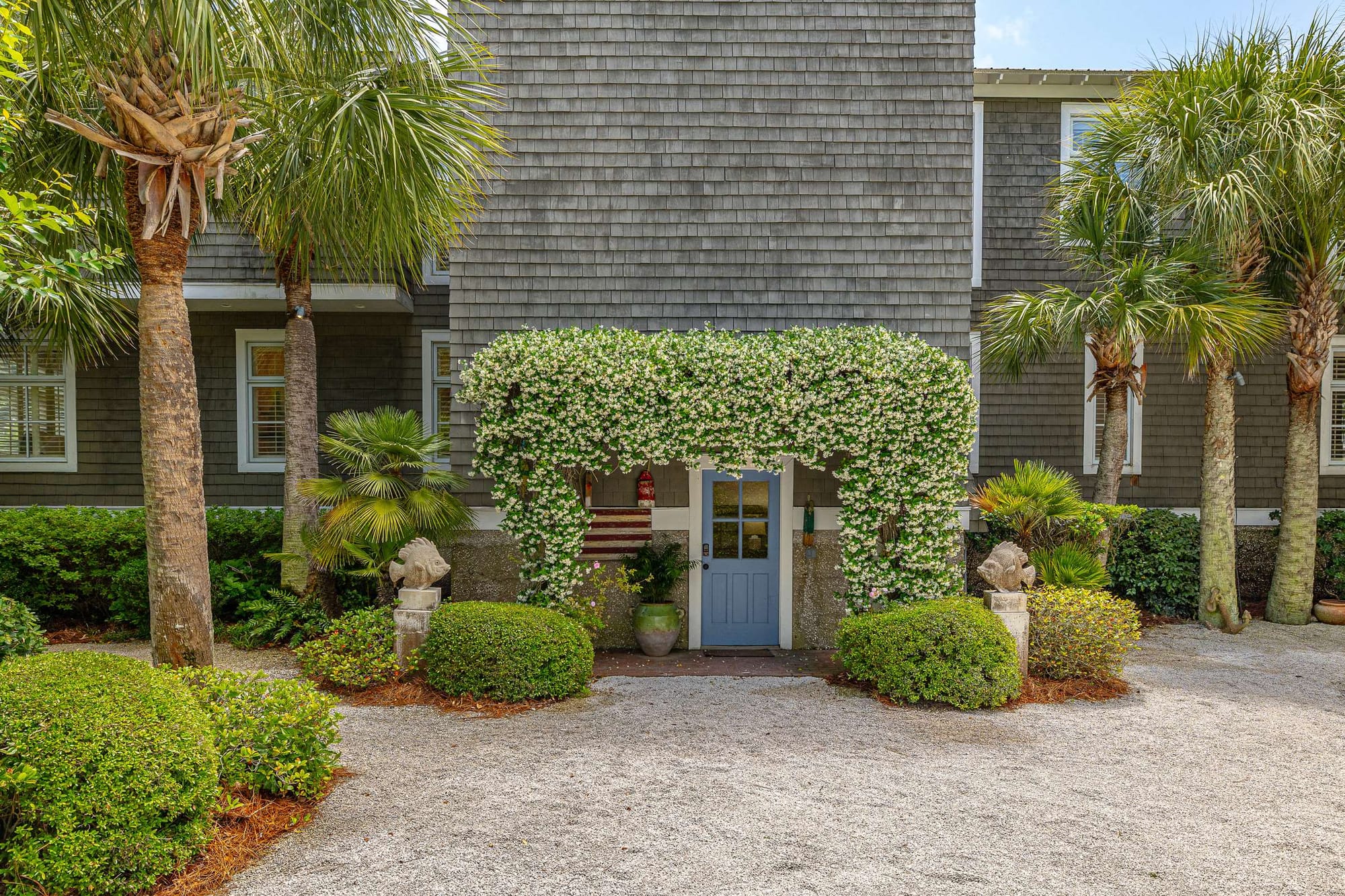 House entrance with lush greenery.