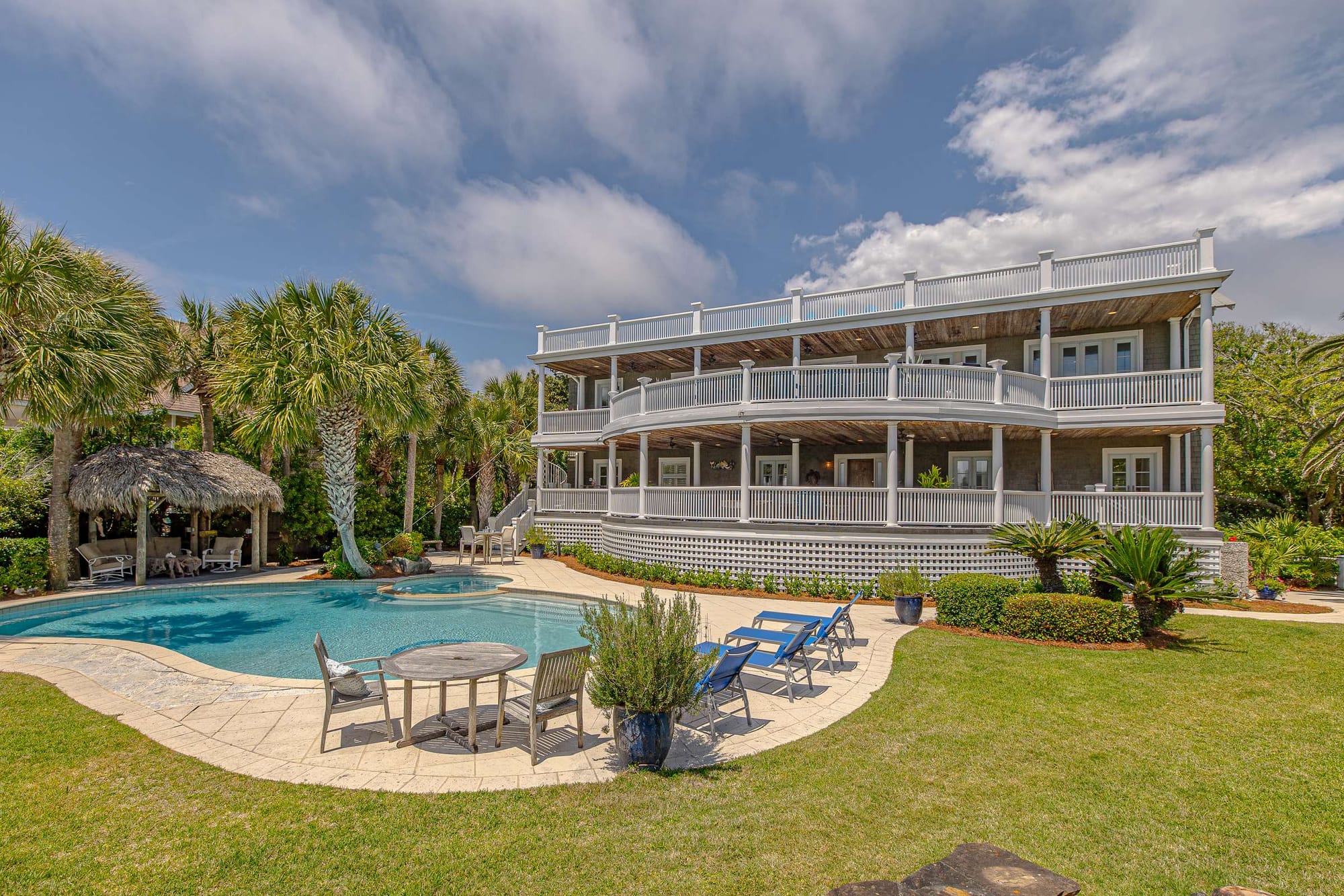 House with pool and loungers.