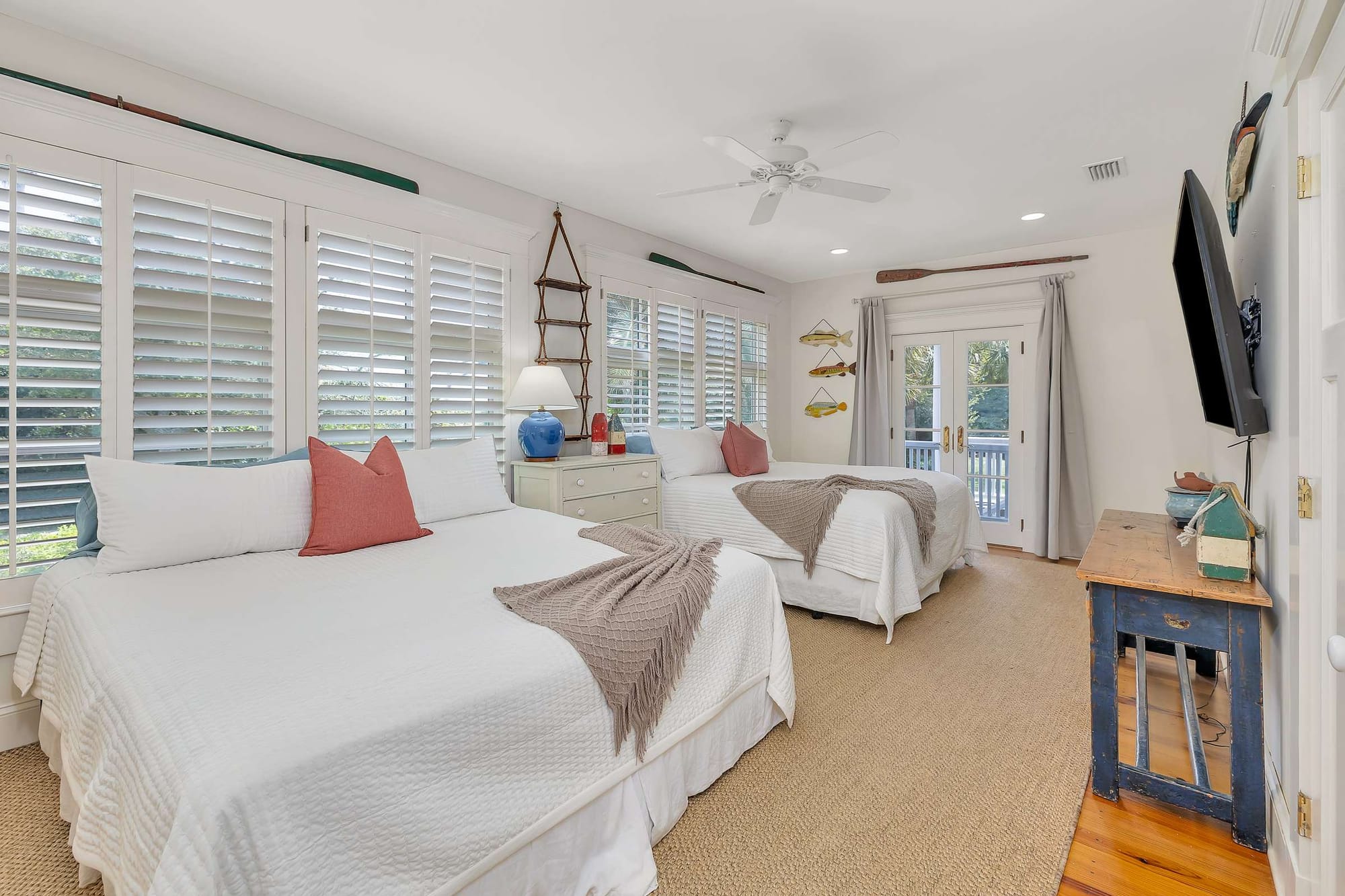 Bedroom with two beds, windows.