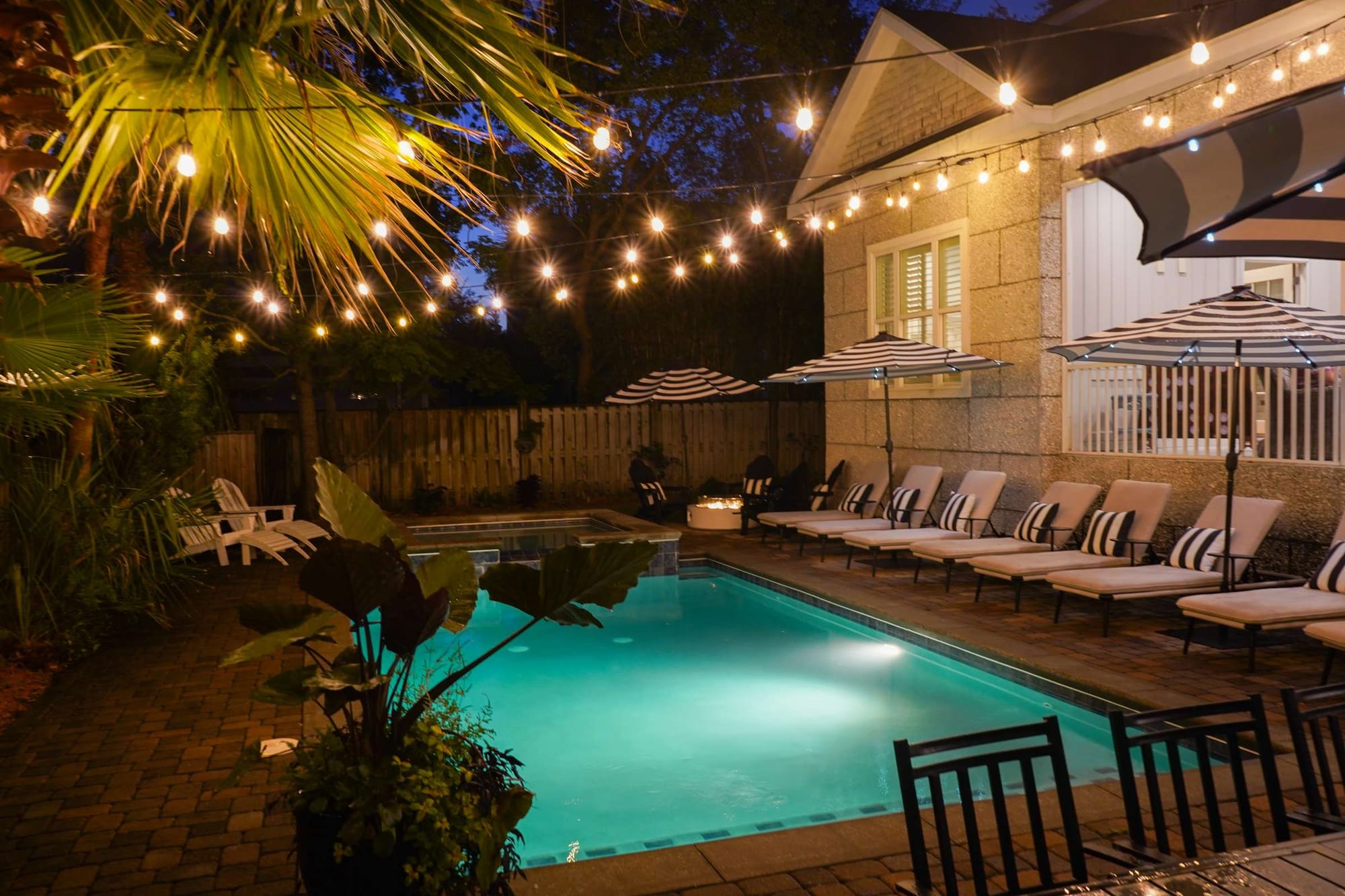 Lit poolside seating at night.