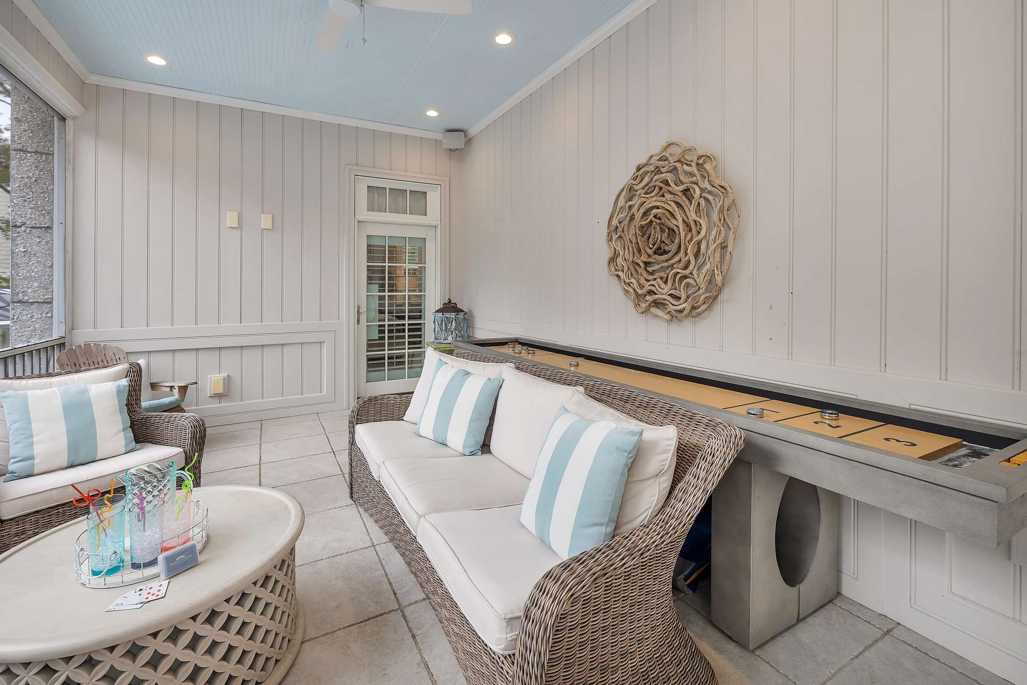 Stylish sunroom with wicker furniture.