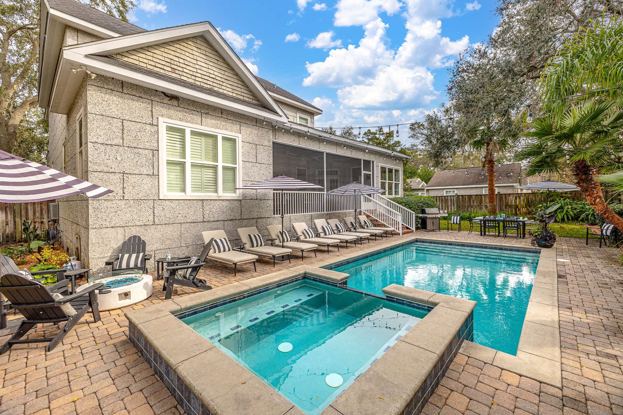 Backyard pool with lounge chairs.