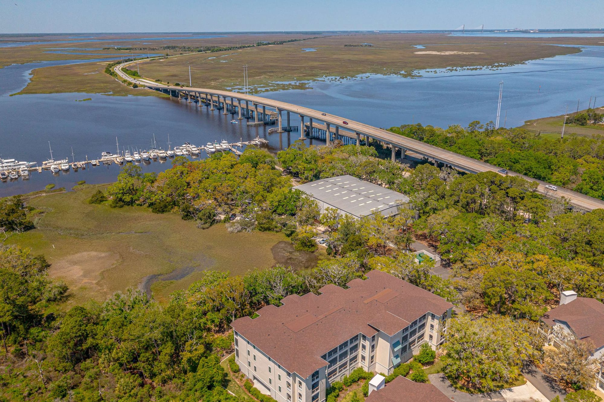 Waterfront view with bridge and boats.