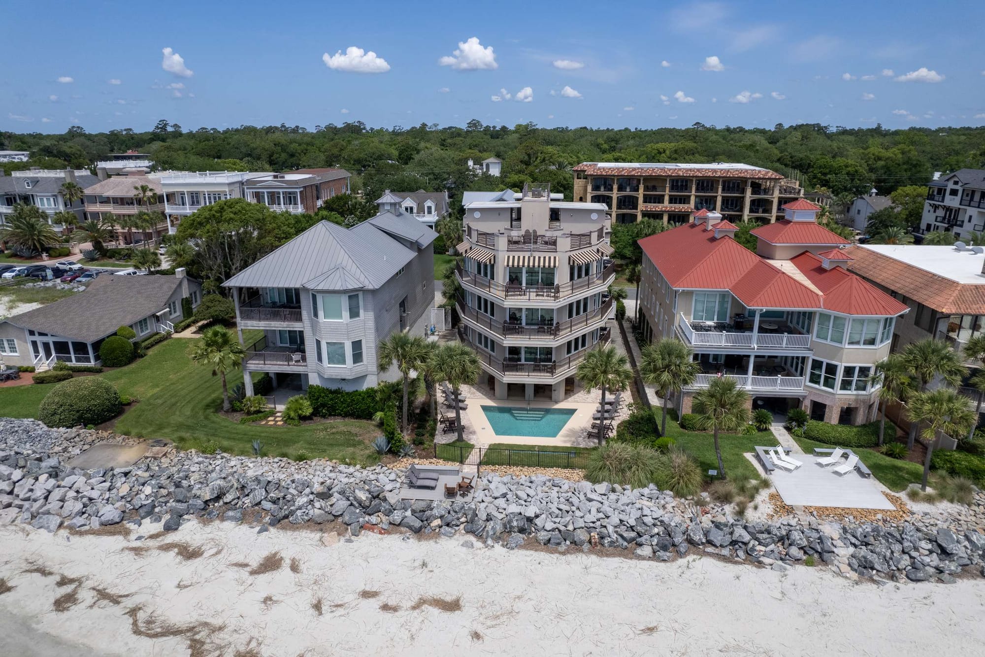 Beachfront houses with pool, aerial view.