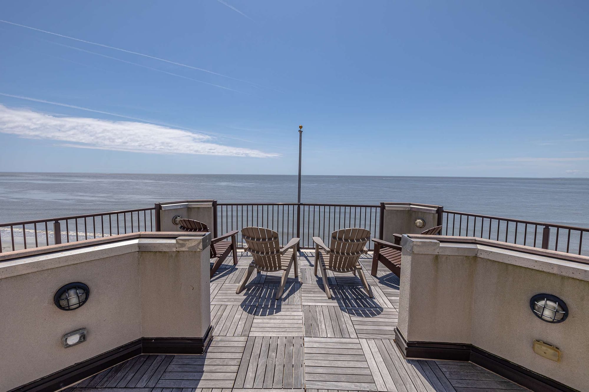 Deck with chairs facing ocean.