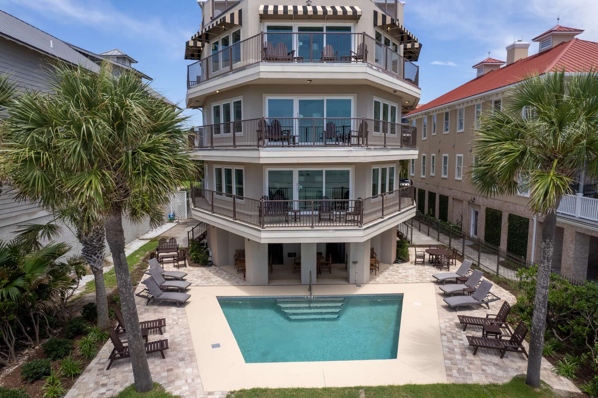 Three-story house with swimming pool.