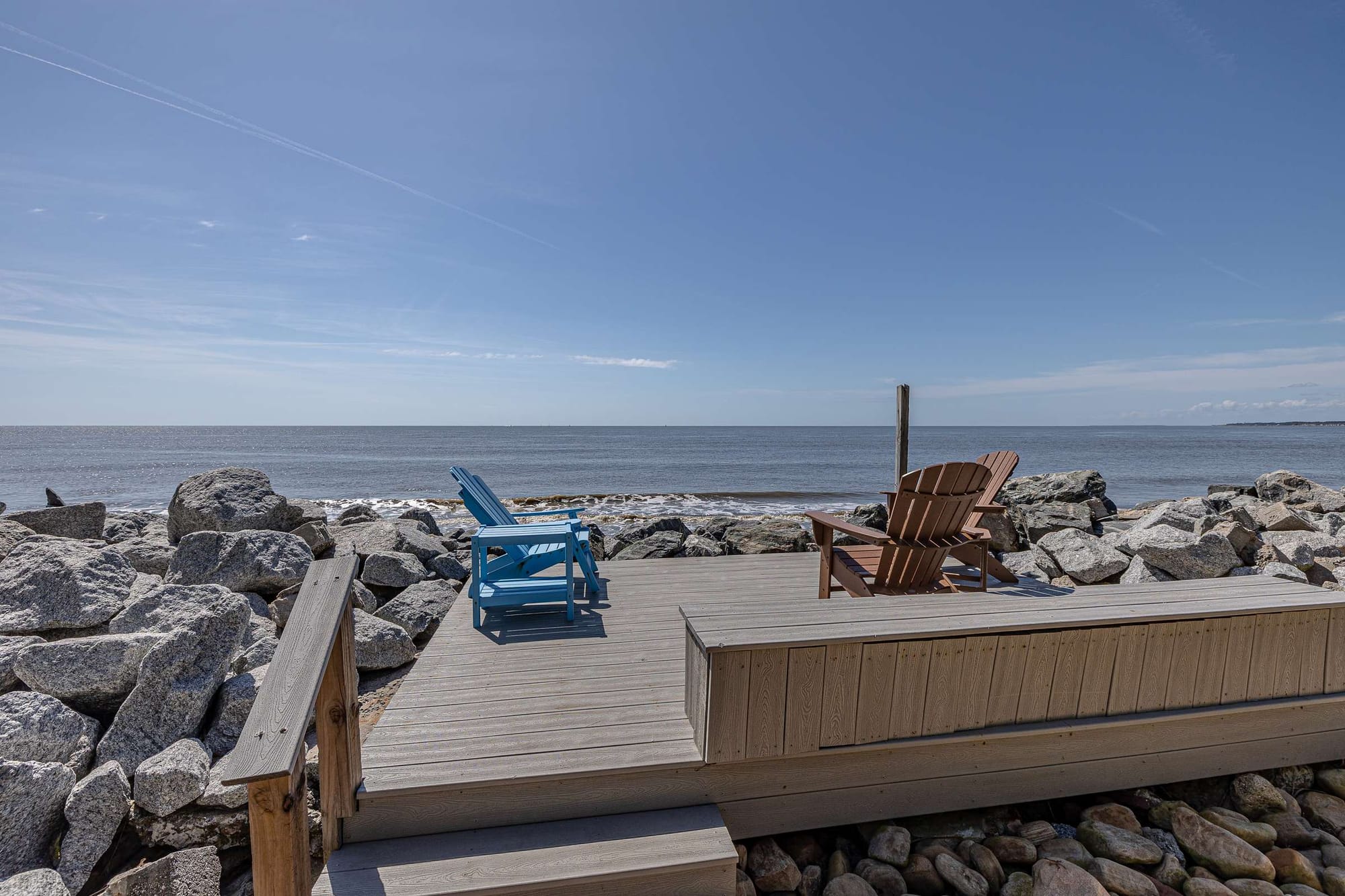 Two chairs on beach deck.