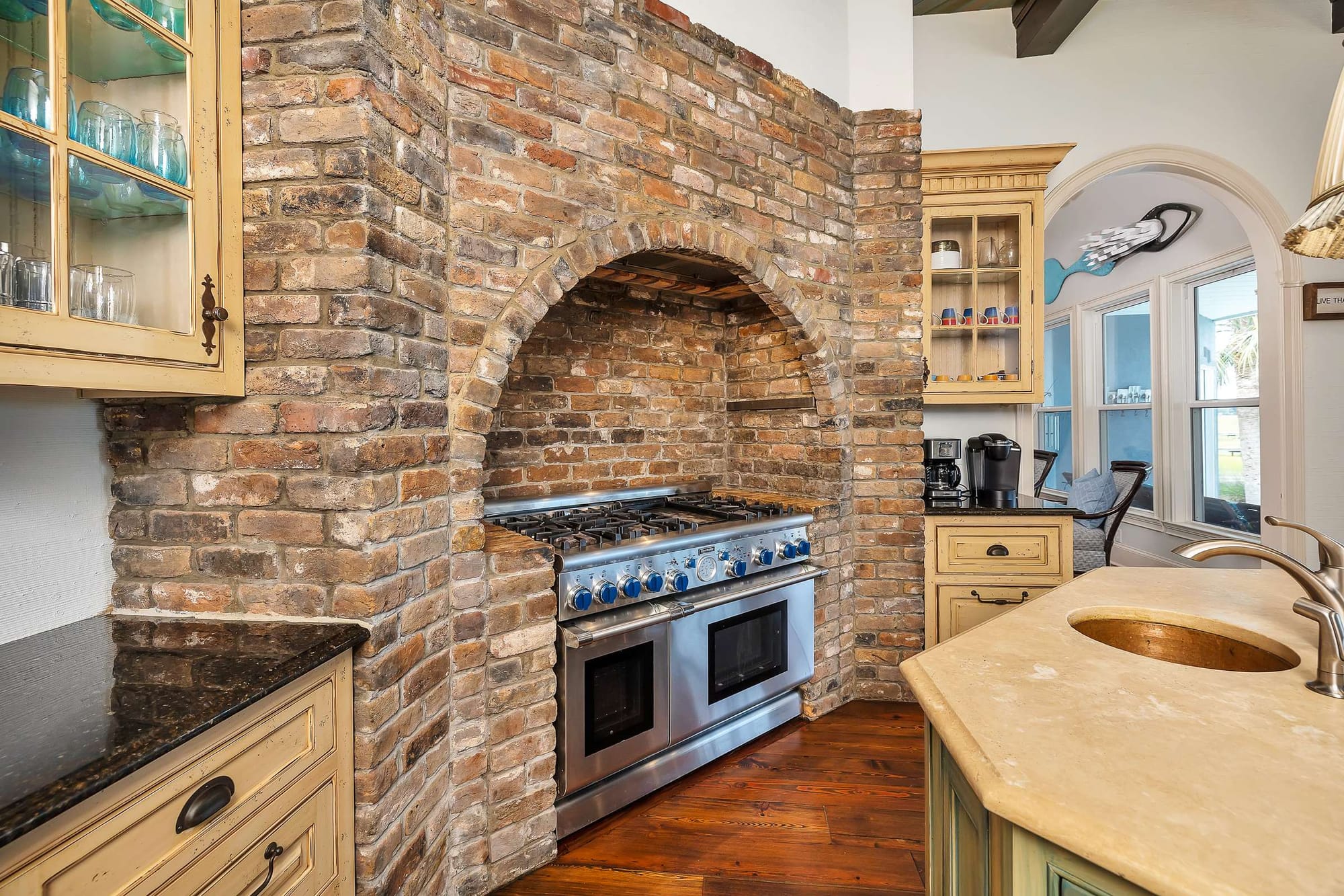 Brick oven alcove in rustic kitchen.