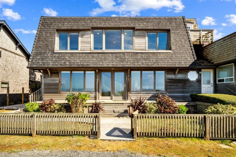 Two-story house with wooden fence.