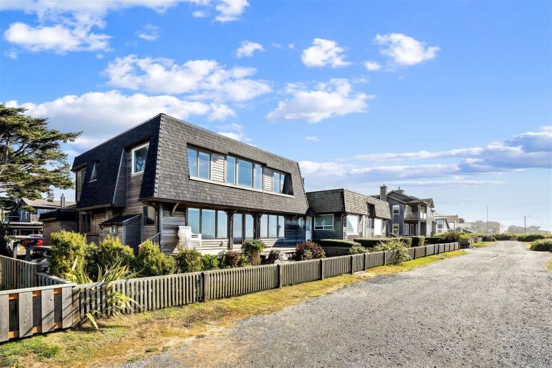 Beachfront houses with wooden fences.