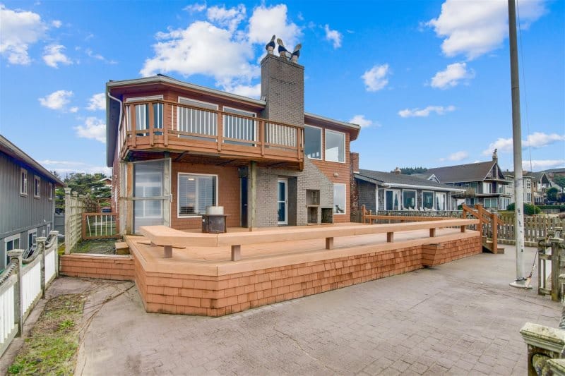 Two-story house with large deck.