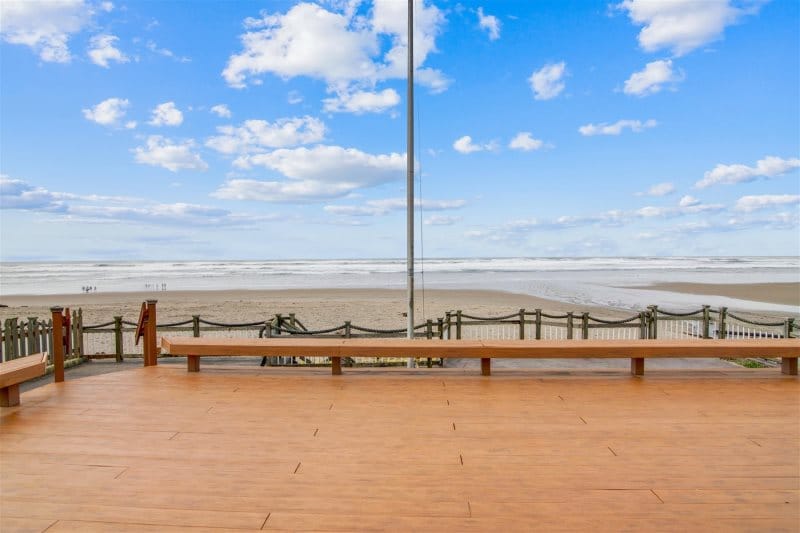 Beach view with boardwalk and benches.