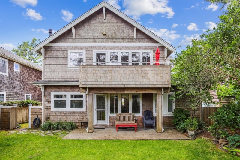 Two-story house with front yard.