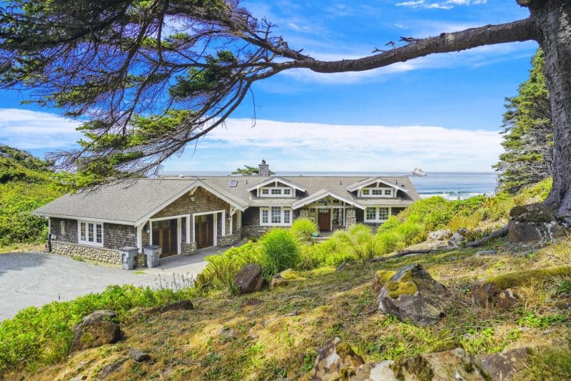 Seaside house with surrounding greenery.