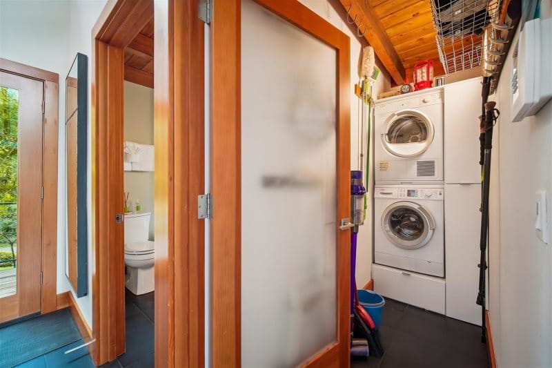 Laundry room with stacked washer dryer.