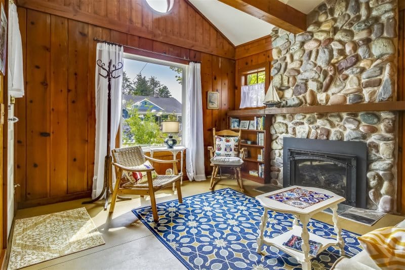 Cozy wood-paneled room with fireplace.