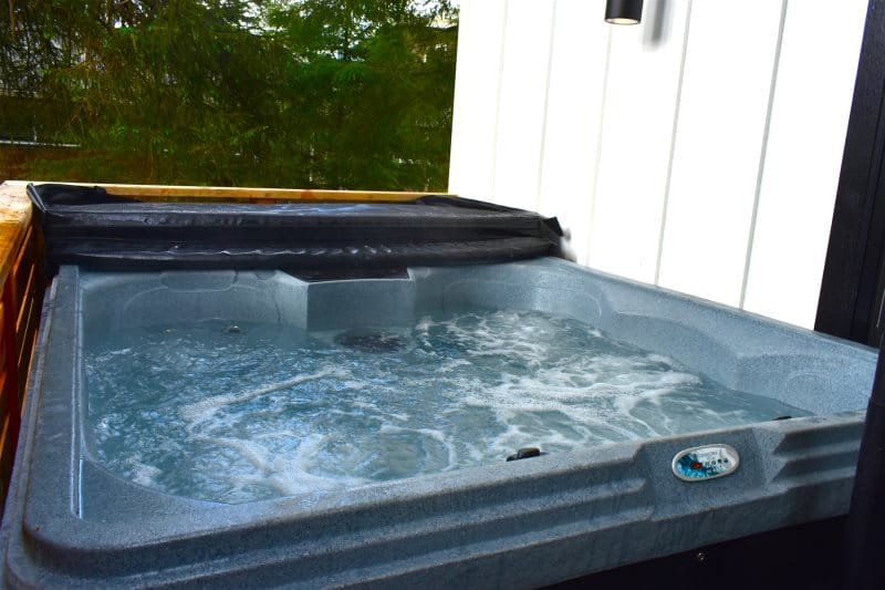 Outdoor hot tub with bubbling water.