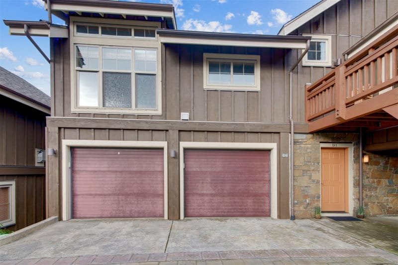 Brown house with two garages.