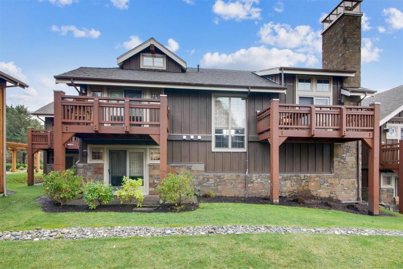 Two-story house with wooden balconies.