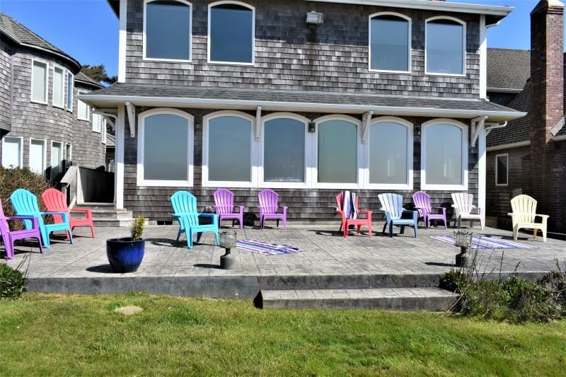 Backyard patio with colorful chairs.