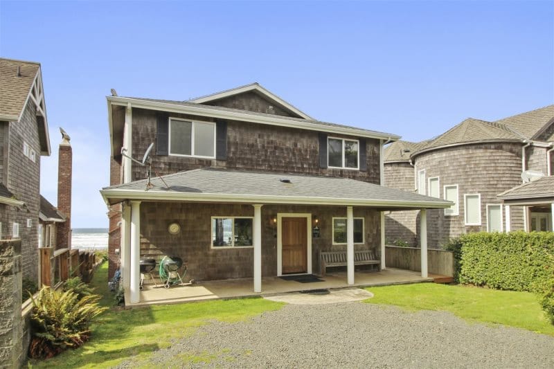 Two-story beachside wooden house.