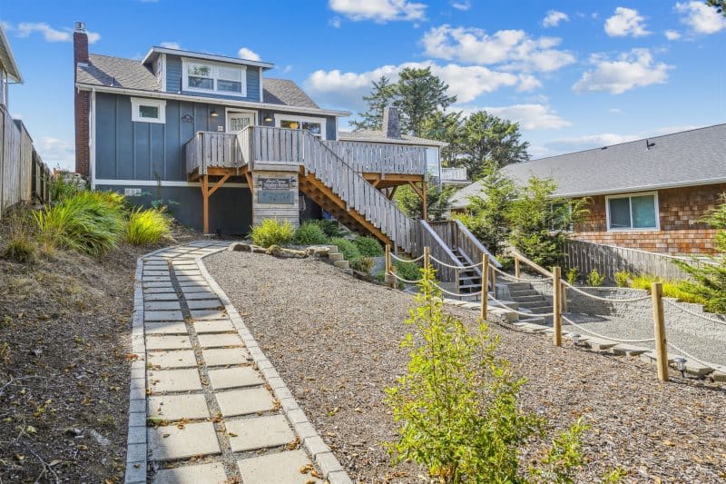 House with wooden stairway, pathway.