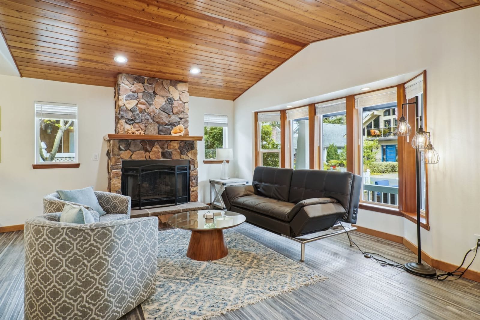 Wooden-ceiling living room with fireplace.