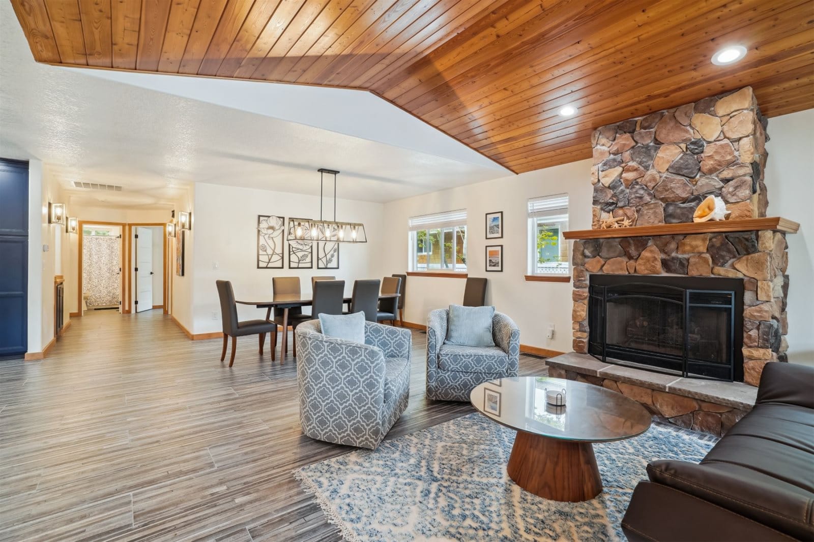 Modern living room with stone fireplace.