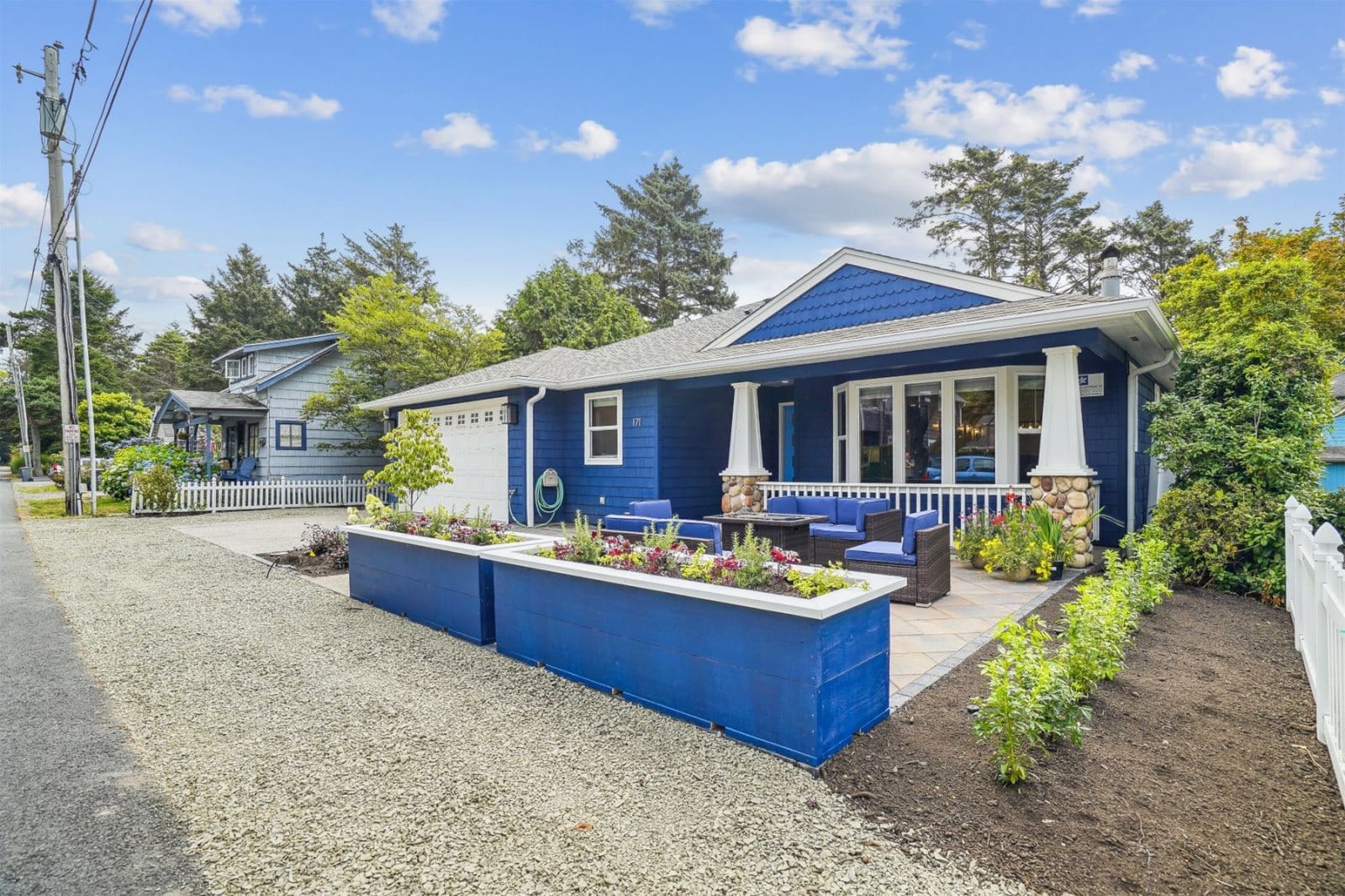 Blue house with garden beds.