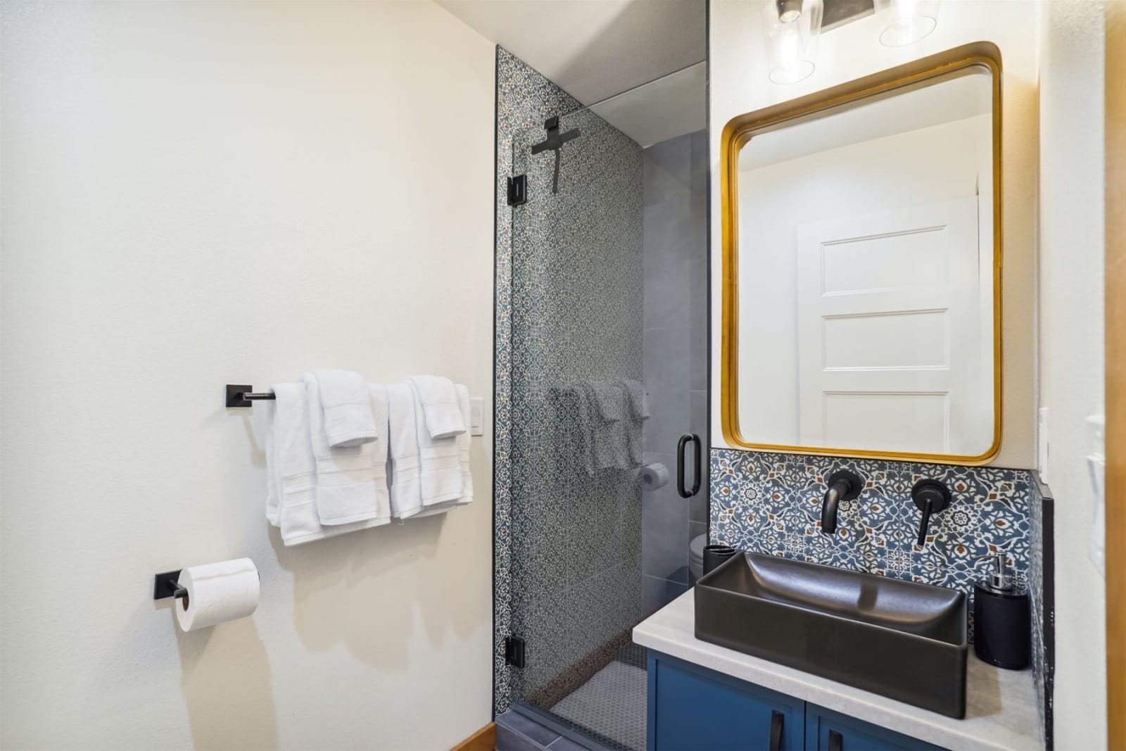 Modern bathroom with shower and sink.