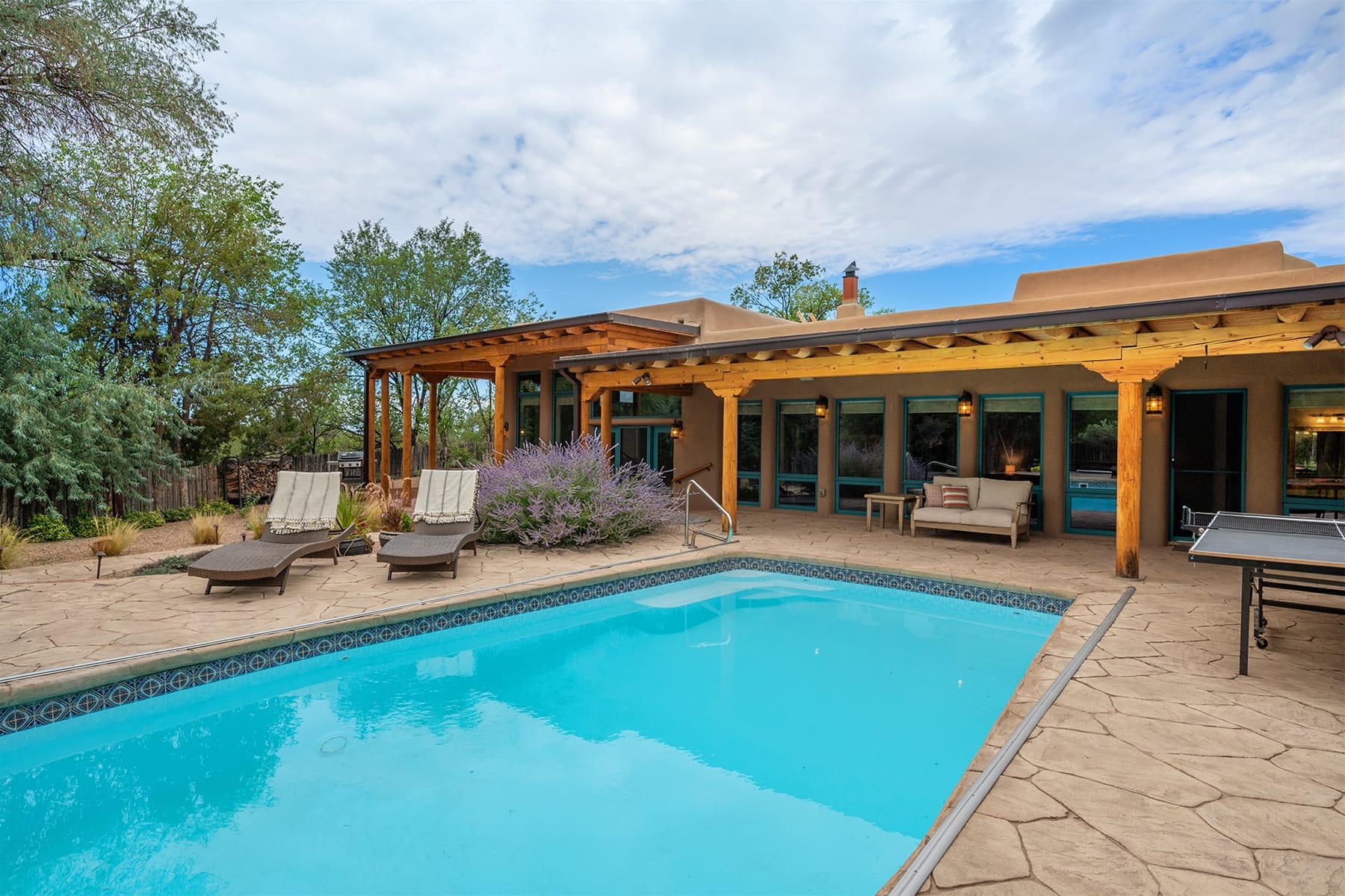 Backyard pool with lounge chairs.