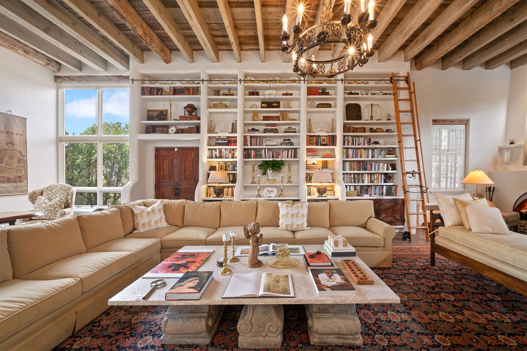 Cozy library living room with chandelier.