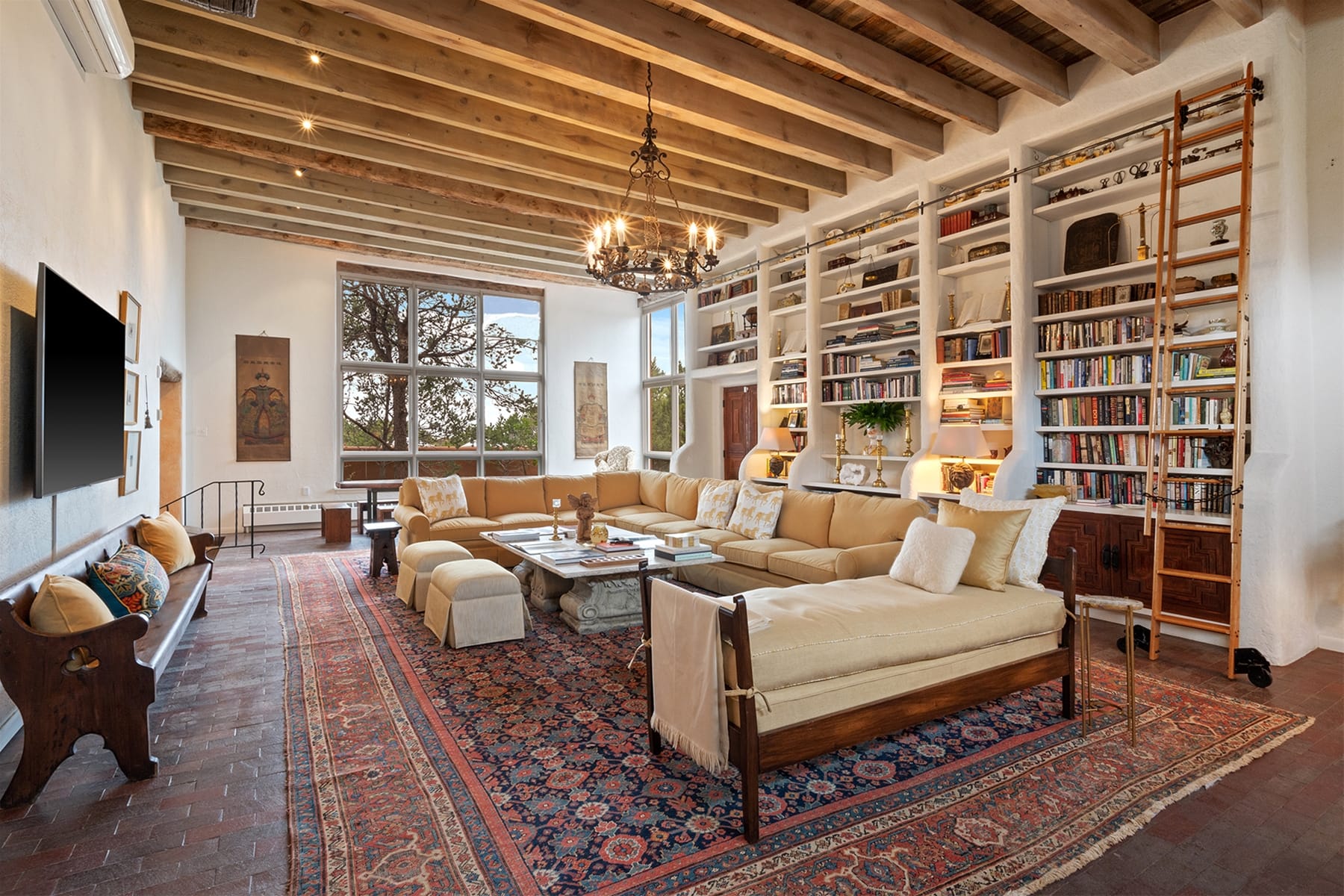 Spacious living room with large bookshelf.