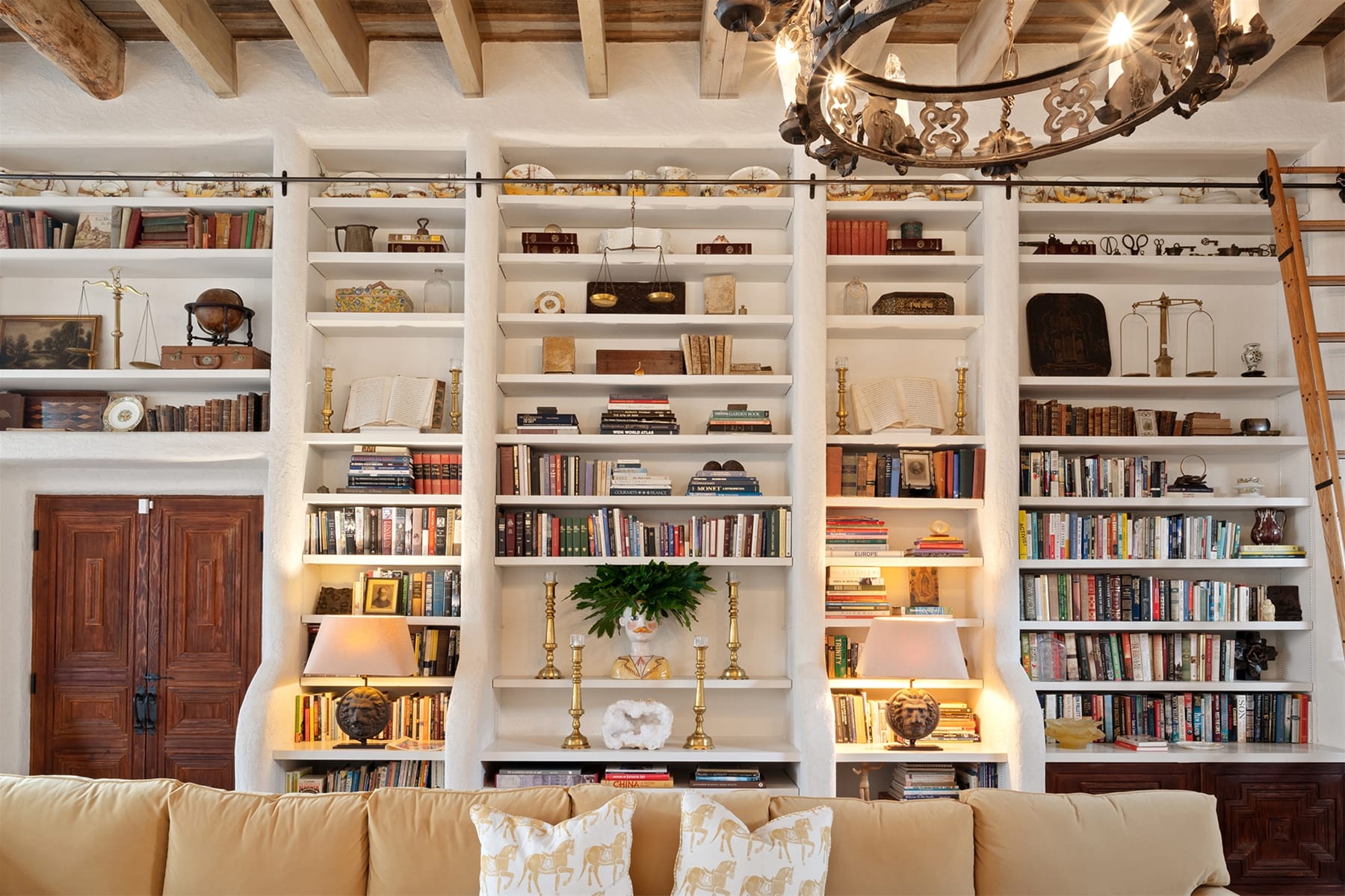 Cozy room with tall bookshelves.