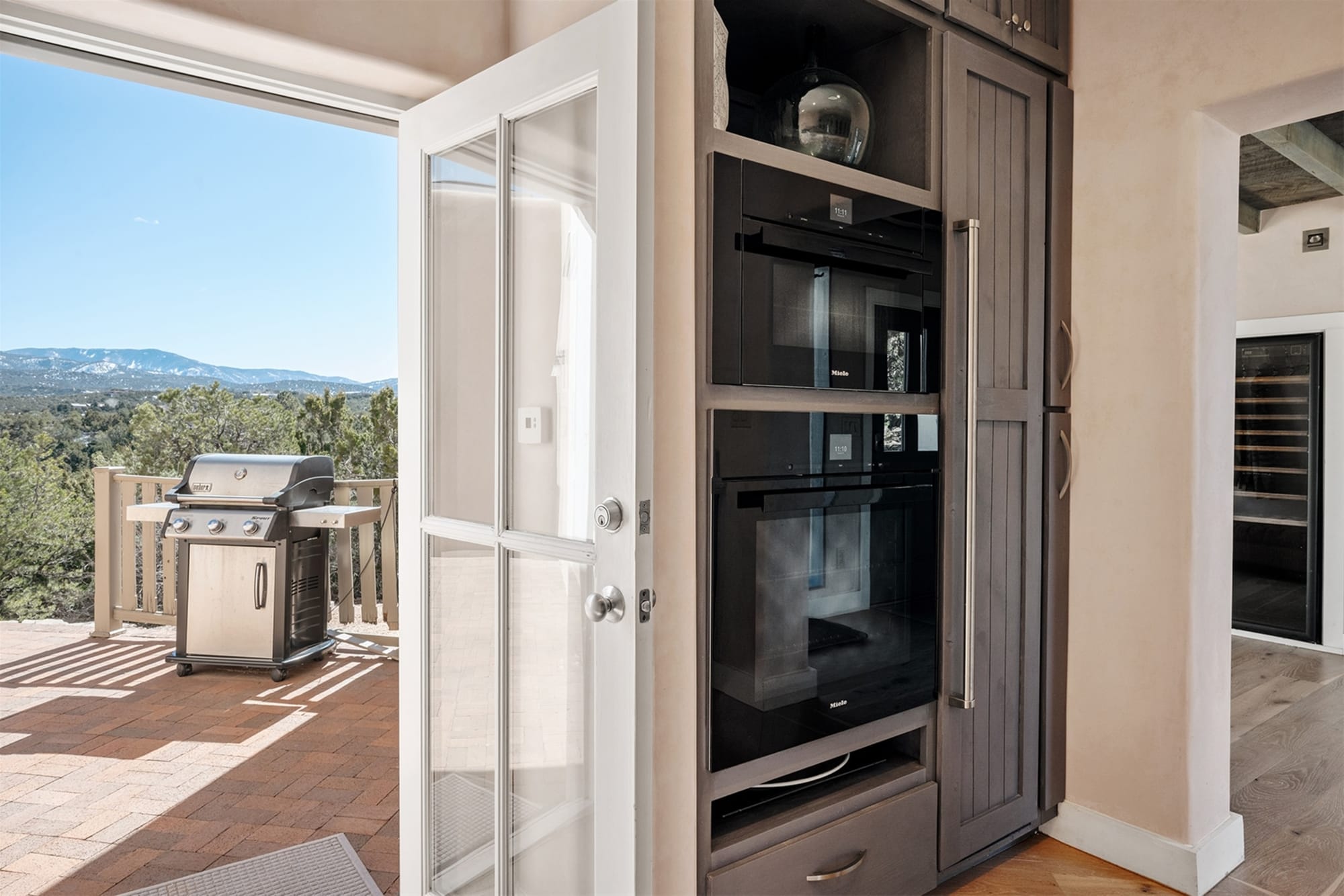 Open door to patio and mountains.