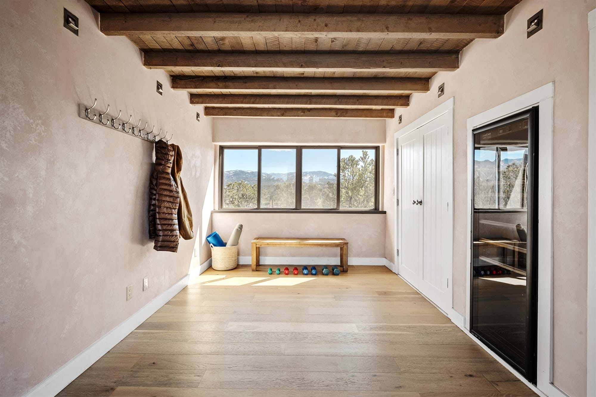 Bright mudroom with wood ceiling.