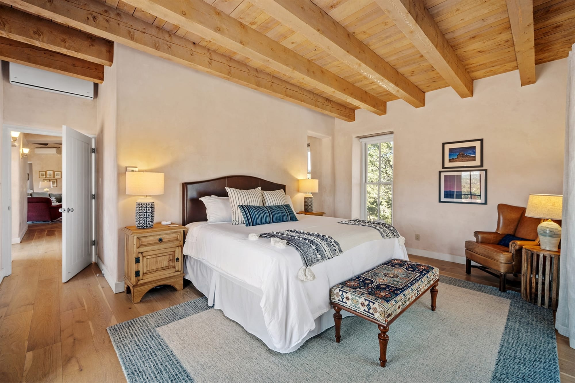 Cozy bedroom with wooden ceiling.