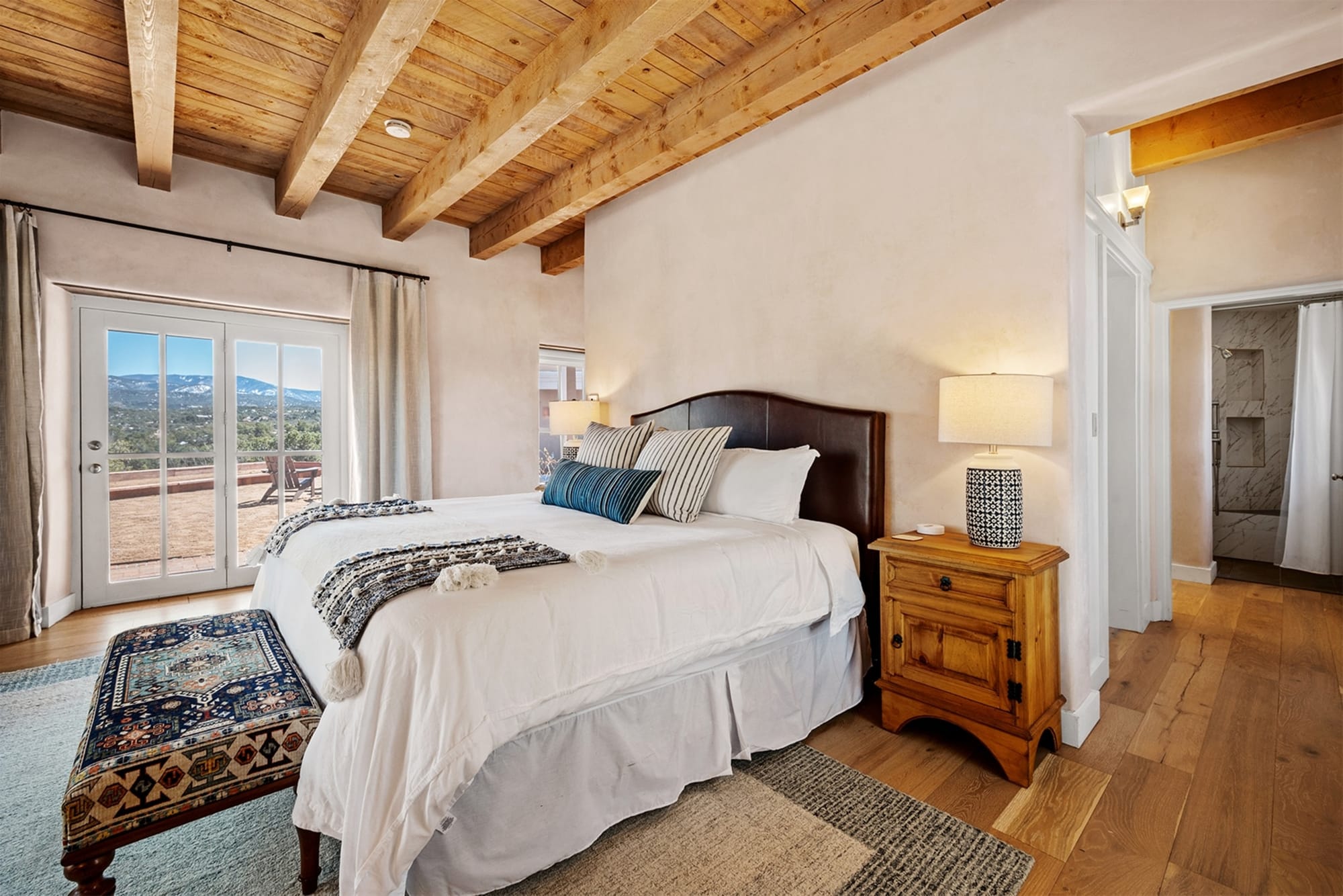 Bedroom with wooden ceiling beams.