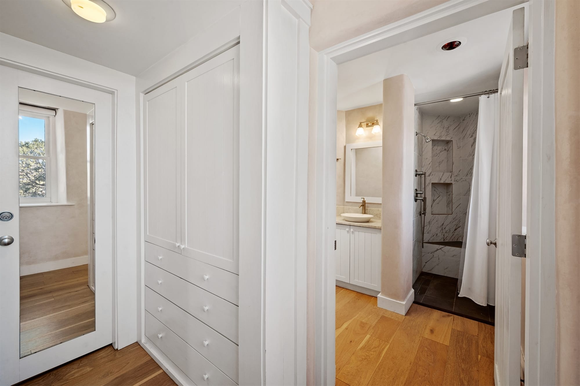 Bathroom and hallway with closets.