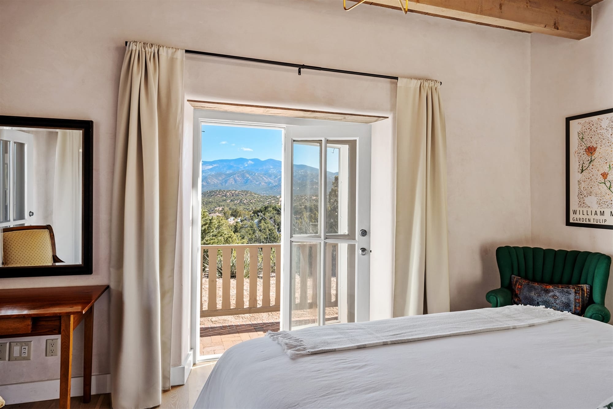 Bedroom with balcony mountain view.